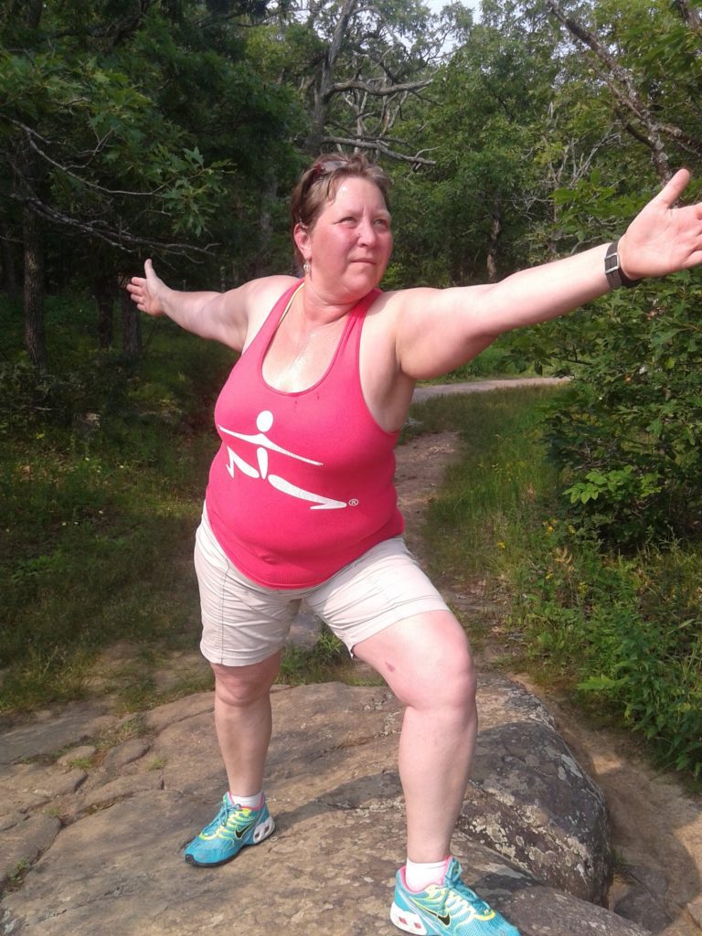 Tammy doing stretches in the wilderness