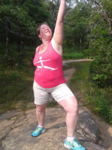 Tammy doing stretches in the wilderness