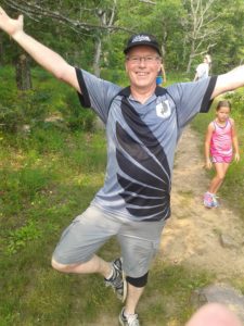 Tammy's husband doing stretches in the wilderness
