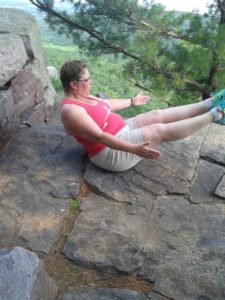 Tammy doing stretches in the wilderness