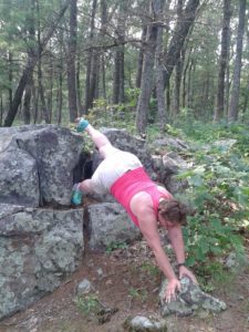 Tammy doing stretches in the wilderness