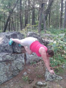 Tammy doing stretches in the wilderness