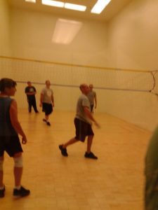 Several adults playing wallyball