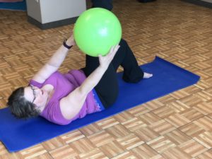 Tammy holding yoga pose on yoga mat