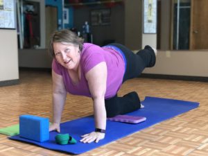 Tammy holding yoga pose on yoga mat