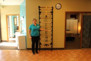 Tammy posing next to exercise ladder at SHIFT's Northeast Minneapolis fitness studio