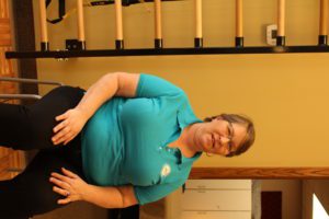 Tammy sitting next to exercise ladder at SHIFT's Northeast Minneapolis fitness studio