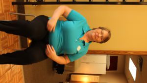 Tammy sitting next to exercise ladder at SHIFT's Northeast Minneapolis fitness studio