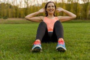young woman exercising outdoors on a soccer field