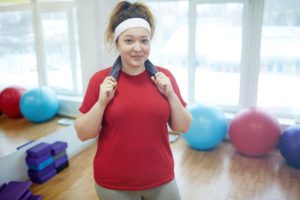 smiling woman after workout in fitness studio