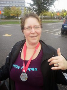 Tammy wearing medal after walk event