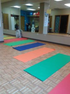 yoga mats on the ground in fitness studio